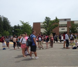 Students wait while teachers search cars