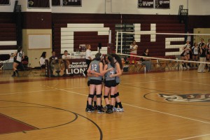 The starting group huddles before the game begins.