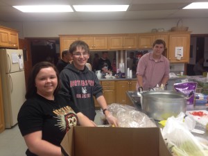Students prepare food in St. Paul's kitchen.