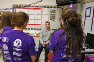 Herren talking with members of the group