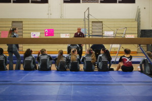 The gymnasts watch their fellow team members compete. Click here to see a slideshow from the meet.