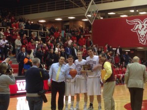 McCord holds the trophy alongside teammates, Bramanti, and principal Antonelli.